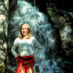 Kristen posing in front of a waterfall at Crystal Sequoia