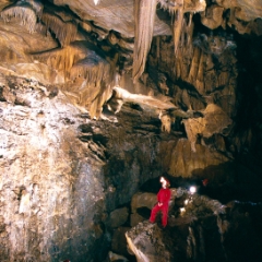 Model in red cave suit in Crystal Sequoia Cave