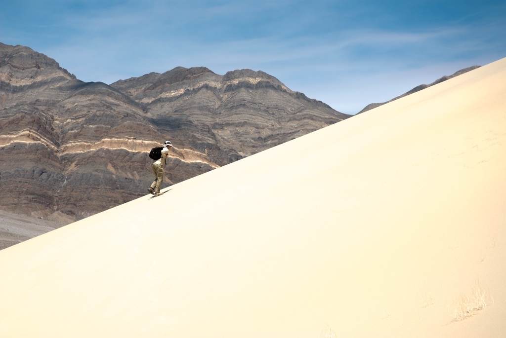 Death Valley, California photograph. Peter climbing the large sand dunes.