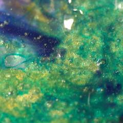 Shiny green blue yellow extremely detailed painting close-up with bubbles