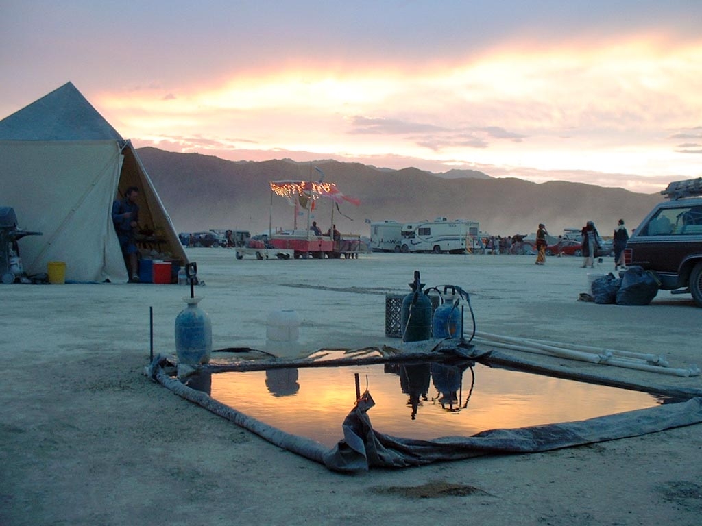 Burning Man 2003 photograph. Pink sunset in our evaporation pond, next to our kitchen tent.