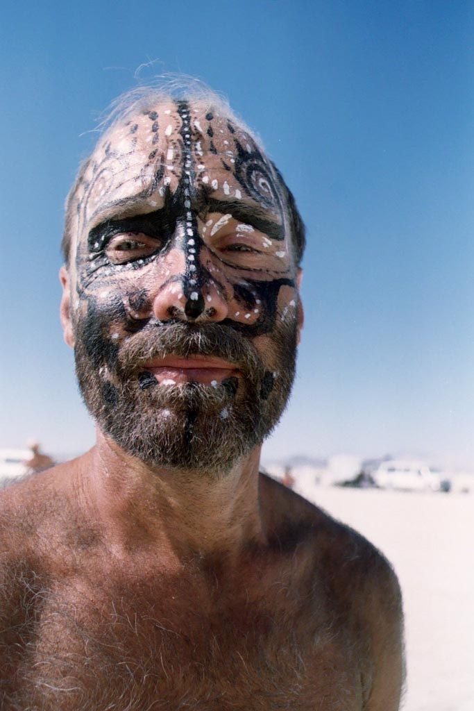 Burning Man 2003 photograph. Man with painted face.