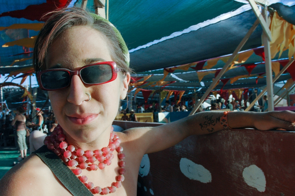 Burning Man 2004 photograph. I love her skin tone, and the large necklace of what looks like grapes around her neck. 
