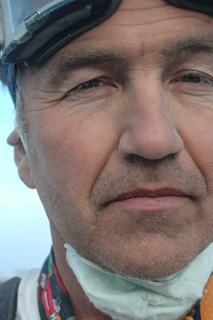 Burning Man 2004 photograph. I like this man's somewhat sad facial expression. 