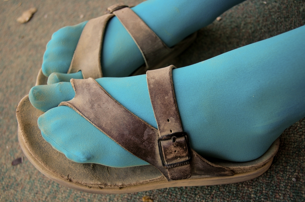 Feet and Shoes photograph. Blue stockings with sandals. I like how the big toe has its own compartment in the sock. 