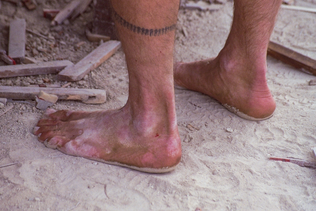 Feet and Shoes photograph. I love these bare feet in the dust, with the tattoo around one ankle.
