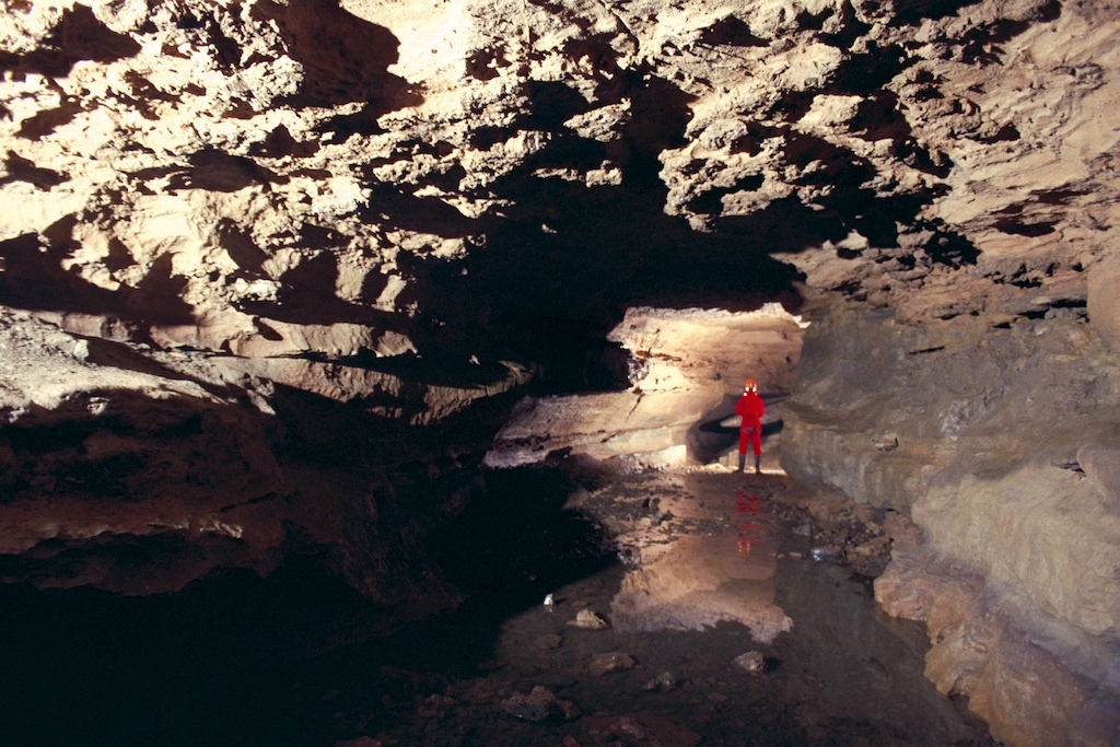 Clarksville Cave, New York photograph. The model is holding a flash gun with Firefly slave attached. The Firefly picks up the signal from my camera when the shutter opens, the flash goes off, and the cave is lit up as you see here.
