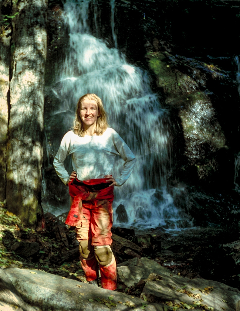 Crystal Sequoia, California photograph. This is men, circa 1998, in my red caver suit, in front of a waterfall. Red suits are standard wear for cavers. I am not sure why but I think because a model in red makes a better photograph.