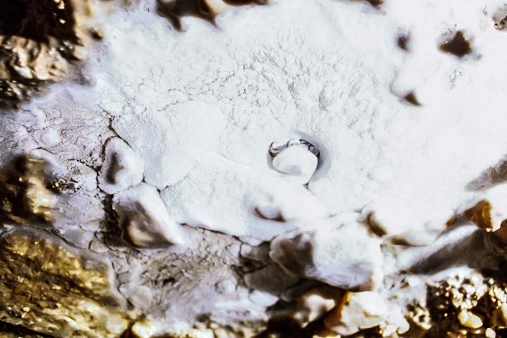 Soldiers Cave photograph. Cave pearls are formed in much the same way a real pearl is formed. From Wikipedia: A cave pearl forms when the water is moving too vigorously to form a stalagmite. A nucleus of matter (such as a grain of sand) becomes coated with calcite, and the current then provides a rotation to the nucleus in such a way that it is coated evenly. In this manner, concentric layers build up over time, in much the same way that a biological pearl forms within a mollusc. There may be microbial action involved in the formation of cave pearls.