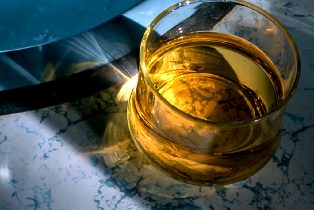 Colorful things photograph. Apple juice with light shining through it. 