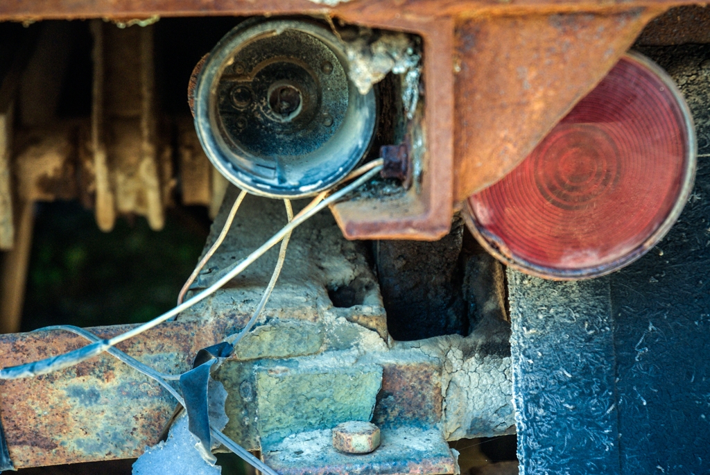 Rusty and abandoned photograph. Rusty interior of some abandoned farm vehicle. Red, orange and blue.