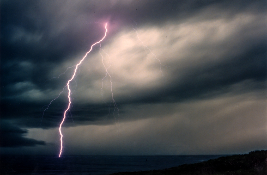 Sky, lightning and clouds photograph. I left my shutter open until the lightning struck. This photo is very old, from before the time of digital cameras.