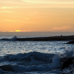 Ocean waves crashing at sunset