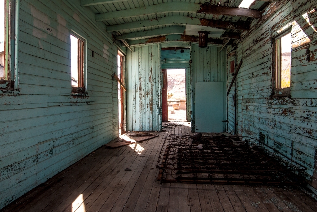 Death Valley, California photograph. I love the teal and brown juxtaposition. Rhyolite was an old mining town near Death Valley that hit its heyday more than a century ago. The buildings are still left standing, though weathered and crumbling.