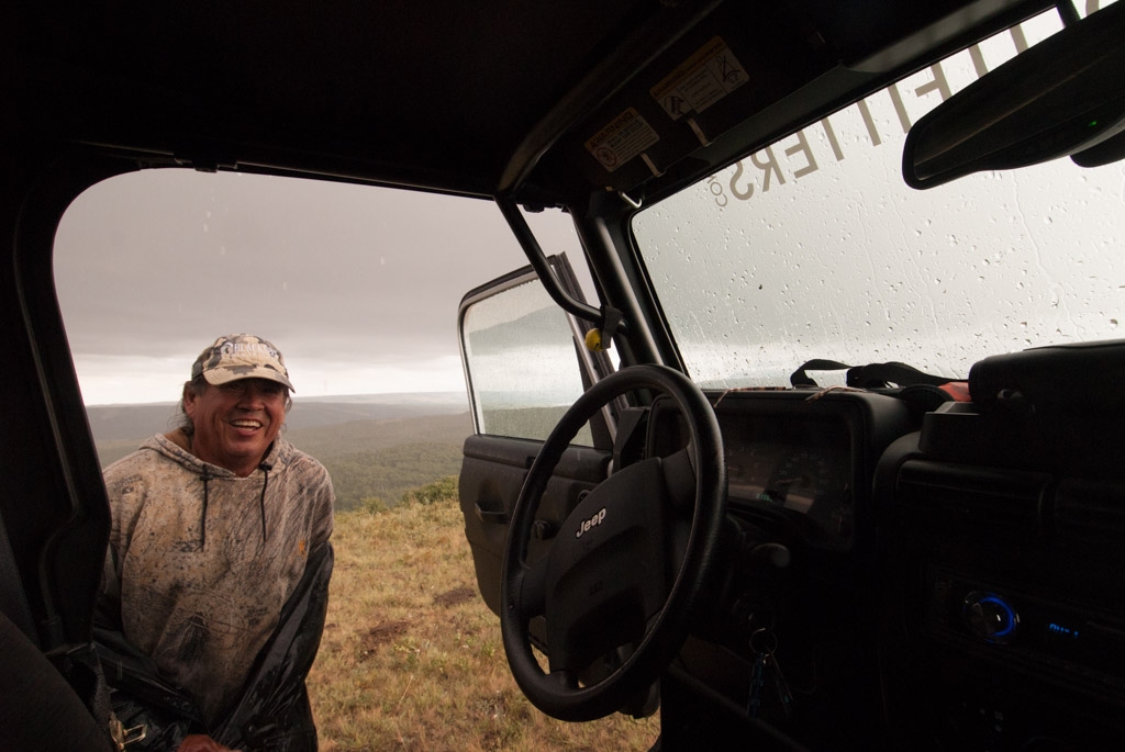 Glacier National Park, Montana photograph. This is the guide who took me on a tour on reservation land from <a href='http://www.blackfeetoutfitters.com/'>Blackfeet Outfitters</a>. He was giving me a jeep tour of the Native lands near Glacier National Park. The jeep ride itself is worth the price alone; I highly recommend the tour. We rode straight over a creek, vroom vroom. In this photo lightning had just struck, and we were both taken by surprise. It didn't really even rain.