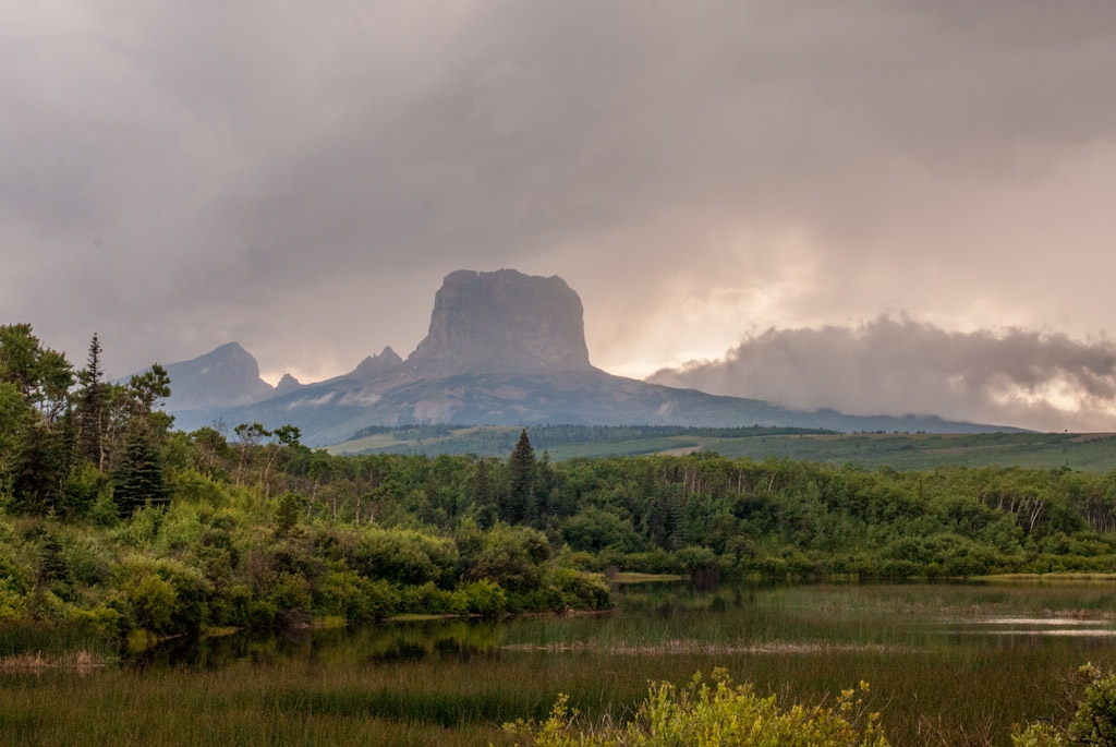 Glacier National Park, Montana photograph. Chief Mountain is located on the eastern border of Glacier National Park and the Blackfeet Indian Reservation. See the <a href='http://en.wikipedia.org/wiki/Chief_Mountain'>wikipedia article</a>. It is very striking because it rises suddenly to 5000 feet above the plain. It was also really beautiful, especially because a storm just hit and then a full rainbow appeared just behind us. The vertical shape of it reminded me of  <a href='http://en.wikipedia.org/wiki/Devils_Tower'>Devils Tower</a>, famous from <a href='http://en.wikipedia.org/wiki/Close_Encounters_of_the_Third_Kind'>Close Encounters of the Third Kind</a>.
