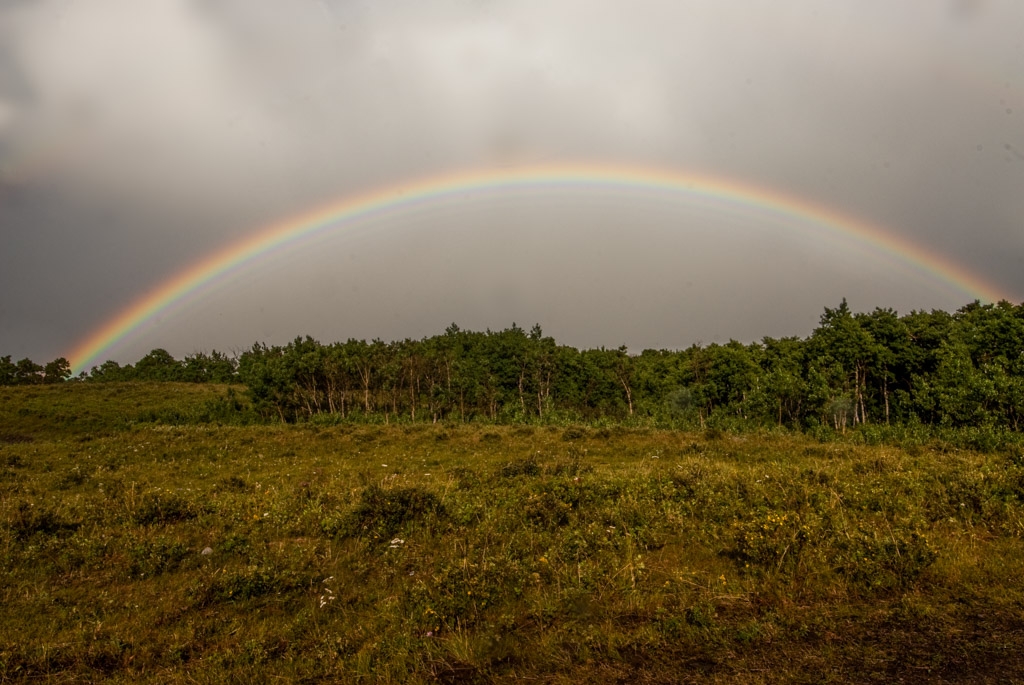 Glacier National Park, Montana photograph. Full rainbow in Glacier National Park, just after a thunderstorm. It was actually a double rainbow but the second one is very hard to see in the photo. If you squint you can sorta see it in the upper left.